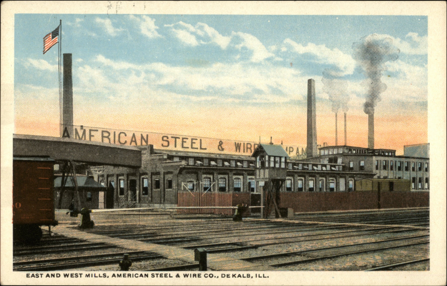 Vintage postcard of American Steel & Wire Co. with industrial buildings and train tracks.