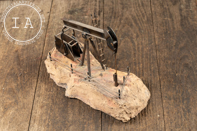 Vintage Oil Pumpjack Model on Stone