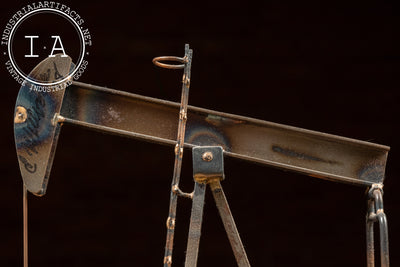 Vintage Oil Pumpjack Model on Stone