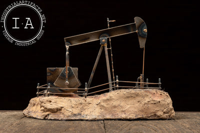 Vintage Oil Pumpjack Model on Stone